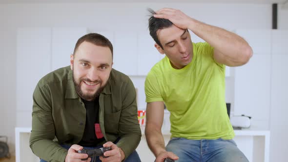 Middle Eastern Man Losing in Video Game and Leaving As Caucasian Guy Rejoicing Win