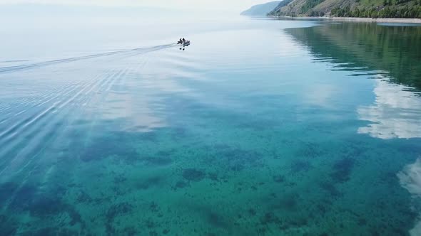 Aerial, Top Drone Scene of Catamaran Anchored in a Bay with Transparent Turquoise Water and