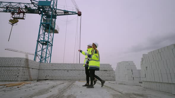 Man and Woman are Walking in Underconstruction Building Civil Engineers in Construction Site