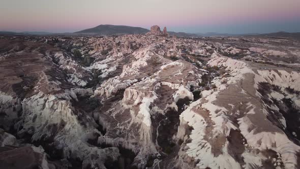 Majestic Sandstone Mountains Forming Caves and Gorges with Uchisar Castle on the Background