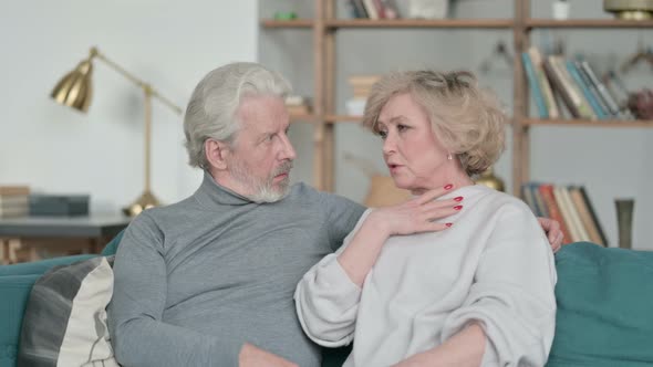 Happy Old Couple Having Conversation While Sitting on Sofa