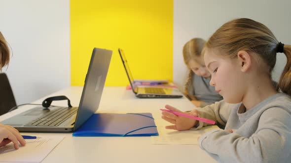 Children writing at desk