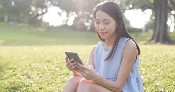 Woman watching on mobile phone at outdoor 