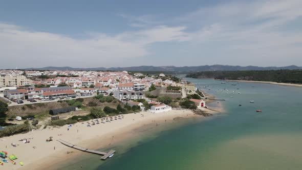 Drone flight over coastal beach along Mira river at Vila Nova de Milfontes in Portugal. Aerial.