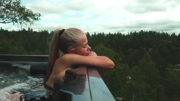 Blond Woman Relaxing In Hot Tub And Leaning On Side