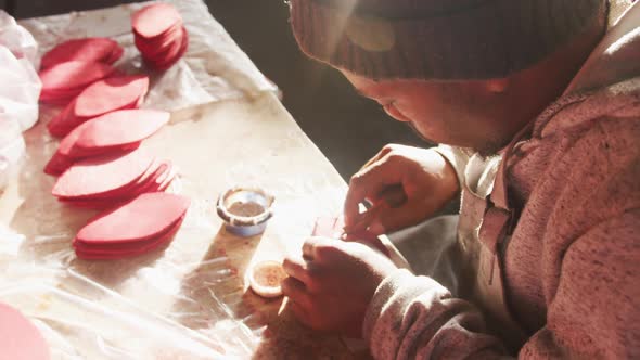 Side view of man working by hand in factory