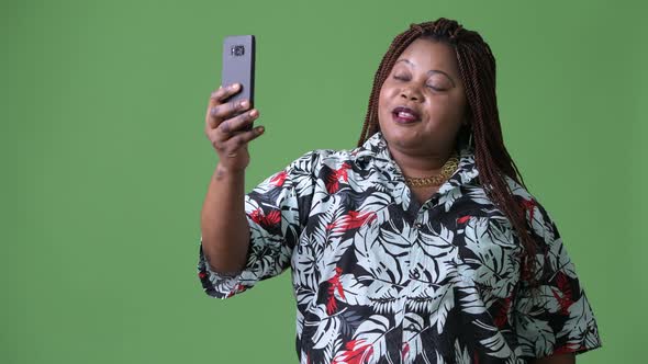 Overweight Beautiful African Woman Against Green Background