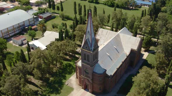 Orbital of beautiful romantic style church surrounded by trees with Santa Anita countryside town in