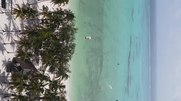 Vertical Video Kitesurfing Near the Shore of Zanzibar Tanzania Aerial View