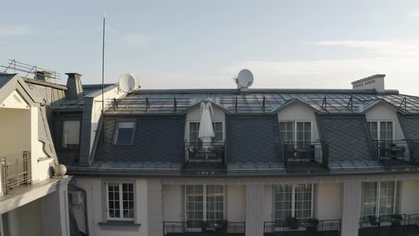 White Wedding Dress Hangs on Special Hanger in Doorway of Balcony of Luxury House Aerial View