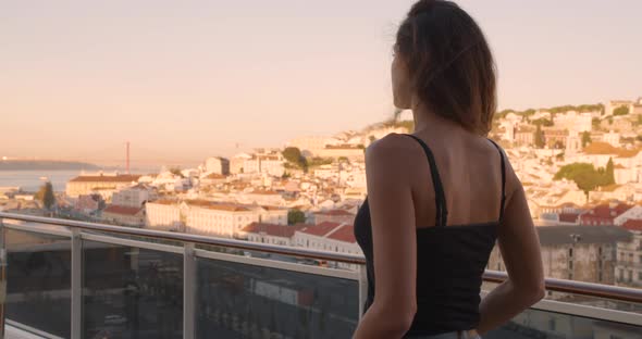 Side View of Woman Which Strolls Along the Historic City of Lisbon Looking at Picturesque View