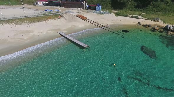 Aerial View of Wooden Pier in Rystal Clean Water Sea