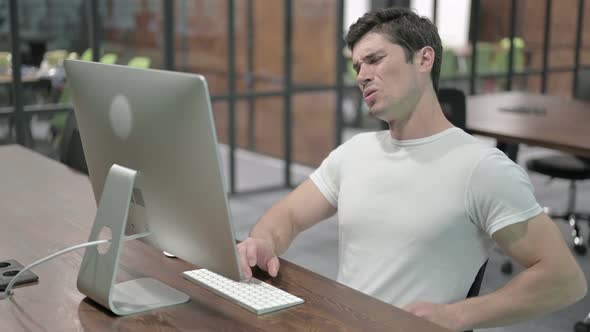 Back Pain, Uncomfortable Young Man Working on Computer