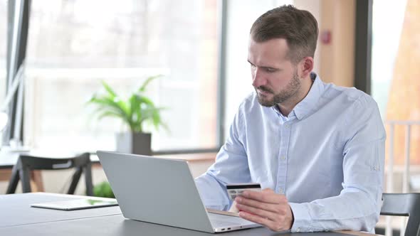 Online Payment Failure By Young Man on Laptop in Office 