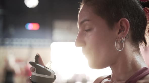 Woman drinking water during workout