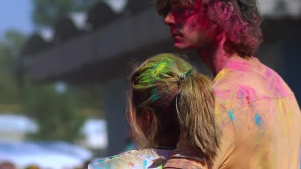 Happy Guy Hugging a Girl During Holi Festival of Colors