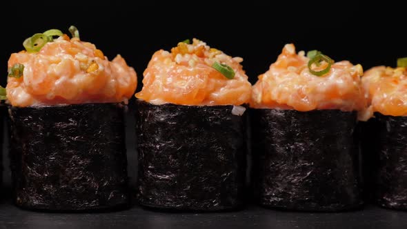 Take One Sushi Roll From Black Slate Board Using Chopsticks