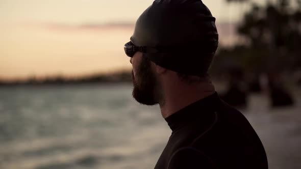 Professional Triathlete Preparing To Swimming Workout On Sea. Swimmer Silhouette In Ocean. Sport.