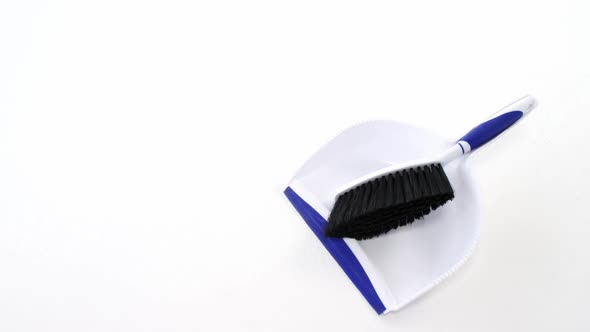 Dustpan and sweeping brush on white background