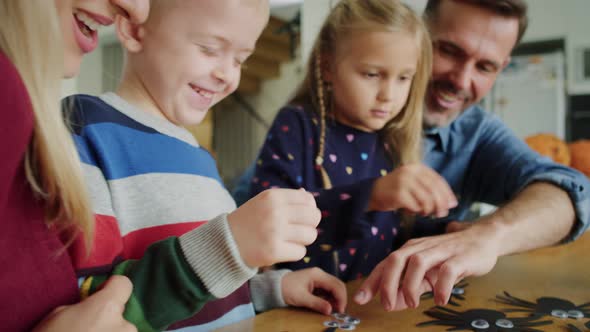 Handheld video of family preparing decorations for Halloween