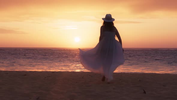 Silhouette of Happy Bride Woman Running By Sandy Beach Cinematic Golden Sunset