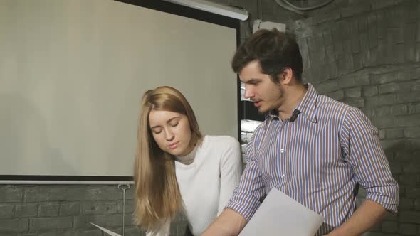 Business Colleagues Doing Paperwork Together at the Office