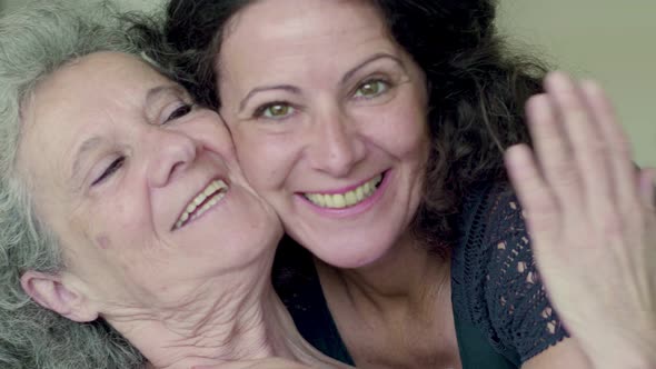 Two Smiling Mature Women Looking at Camera.