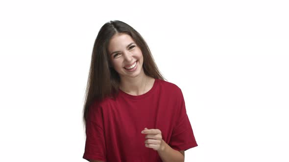 Lifestyle Shot of Attractive Smiling Woman in Red Tshirt Laughing and Feeling Happy Standing Against