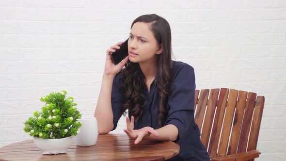 Angry Indian girl talking on a call