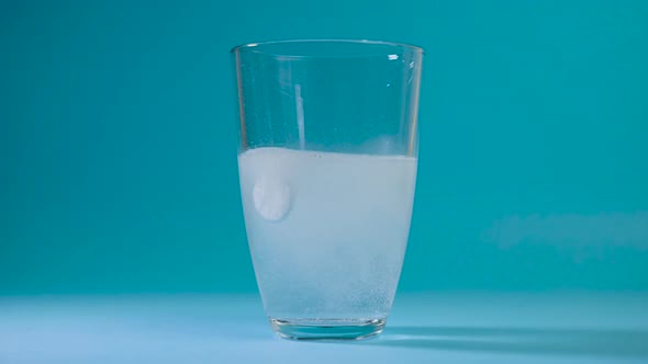 Transparent Glass Cup of Water Drops Analgin Tablet