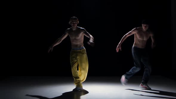 Two Breakdance Dancers with Naked Torso Continue Dance, on Black, Shadow