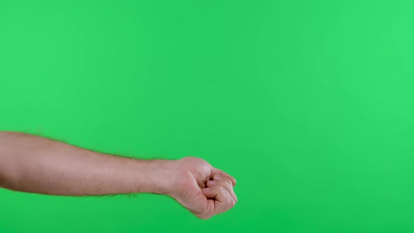 The Woman Measures the Temperature of the Man Against the Background of the Green Screen