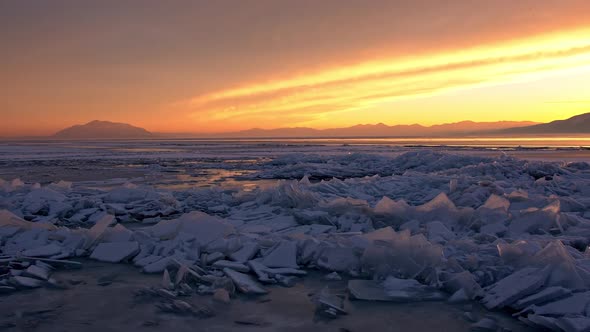 Broken ice sheets on the edge of Utah Lake during sunset