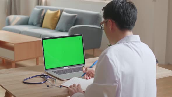 Doctor Video Call On Laptop Computer With Green Screen And Consult Client Online At Home Office