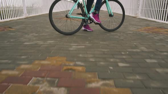 A Young Hipster Girl Standing with Fixed Gear Bike at City Centre on Bridge Slow Motion