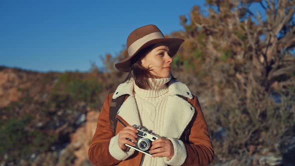 Young girl with a retro camera 