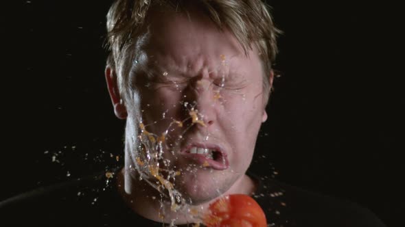 Slow motion shot of tomato hitting man in face, shot on Phantom Flex at 2000 fps