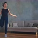 Pretty Slim Woman in Sportswear Jumps Rope in Living Room - VideoHive Item for Sale