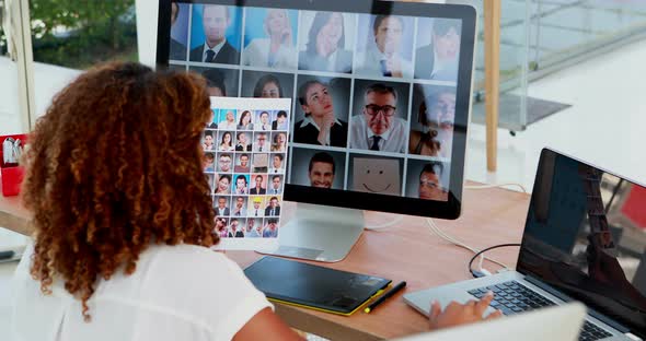 Graphic designer looking photos on computer at desk 4k