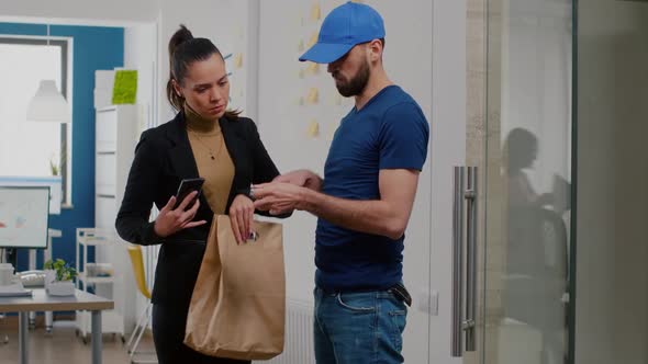 Delivery Man Bringing Takeaway Food Meal Order to Businesswoman in Startup Company Office
