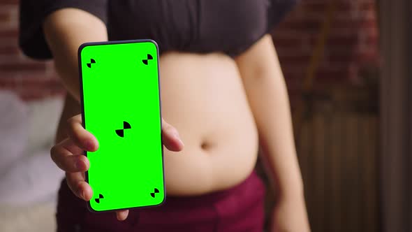 A Closeup of the Fat Woman Shows the Smartphone