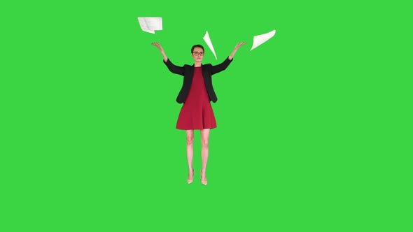 Business Woman in Red Dress Throws Away Documents on a Green Screen, Chroma Key