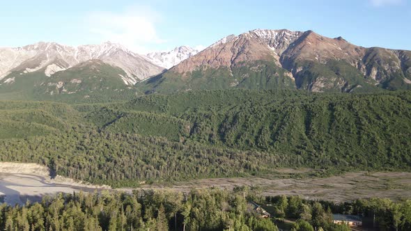 Aerial flight panning along the Matanuska River in the Talkeetna Mountains.  Filmed along the mounta