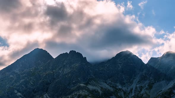 Mystic Light of Sunrays and Clouds Motion over Misty Alps Mountain Landcape