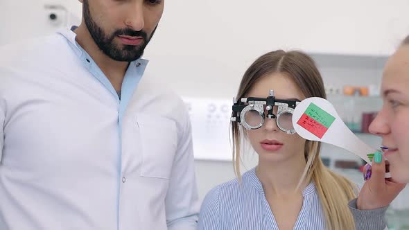 Eye Exam. Doctors Checking Woman Eyesight With Optometry Glasses