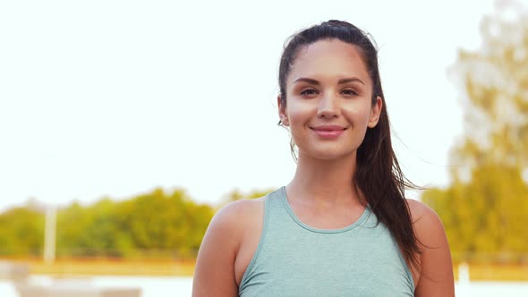 Portrait of Smiling Young Sporty Woman Outdoors