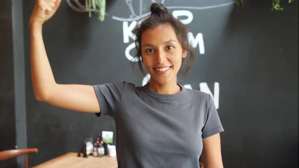 Vegan Girl Holding Wooden Sign Plant Power and Showing Strong Biceps. Healthy Lifestyle Propaganda