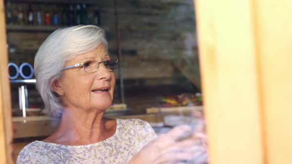 Senior woman interacting in cafe 4k