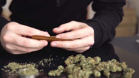 Man Rolling Marijuana Cannabis Blunt. Man Rolling a Marijuana Weed Blunt. Close Up Marijuana Joint