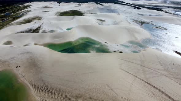 Sand dunes mountains and rain water lagoons at northeast brazilian paradise.